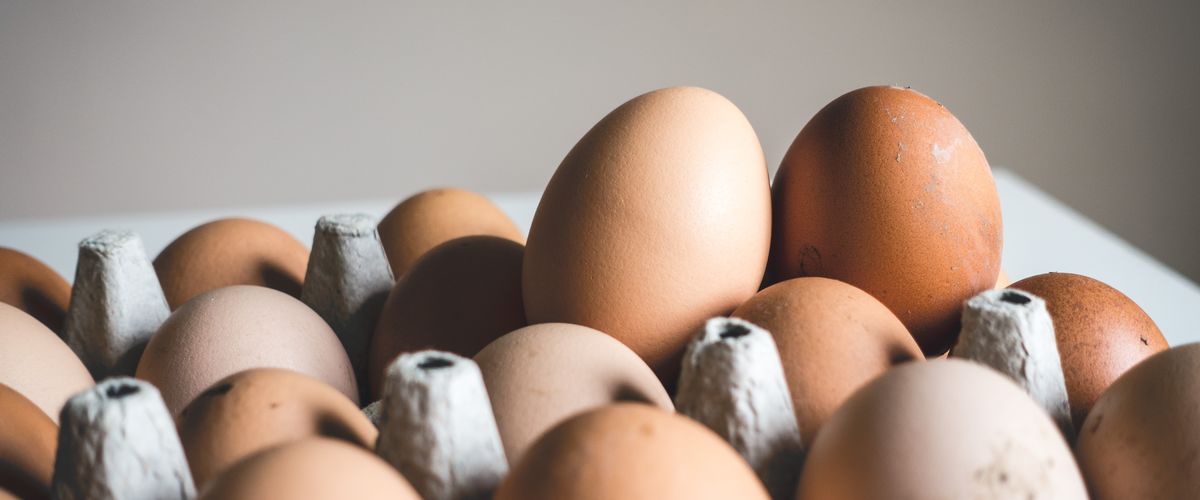 A group of fertile brown eggs on a table.