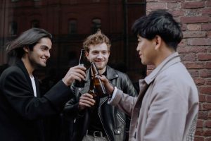 male drinking and saluting each other